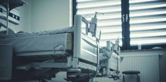 Empty hospital beds by a window
