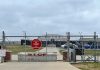 Chain link fence with Restricted Area Stop No Photography sign