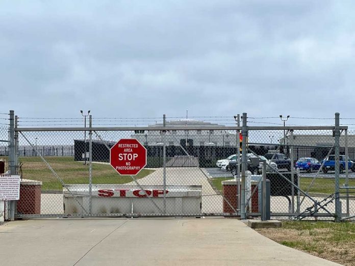 Chain link fence with Restricted Area Stop No Photography sign