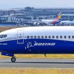 Boeing 737800 on airport runway with other planes