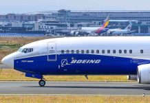 Boeing 737800 on airport runway with other planes