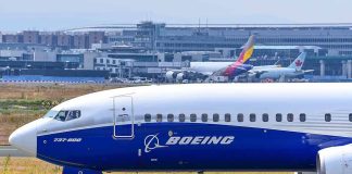 Boeing 737800 on airport runway with other planes