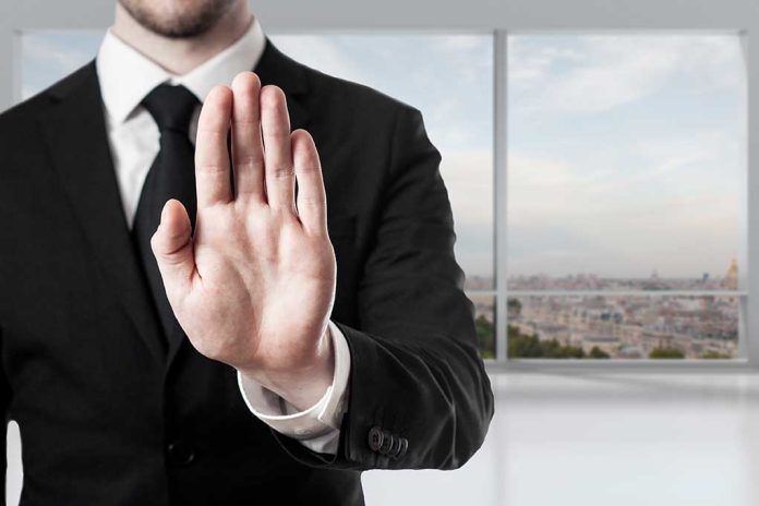 275001506 featured image Person in suit with hand raised in stop gesture