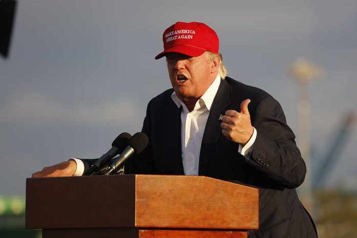 318051161 featured image Person speaking at a podium wearing a red hat
