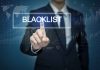 Man pressing virtual blacklist button