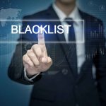 Man pressing virtual blacklist button