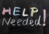 Help Needed written in colorful chalk