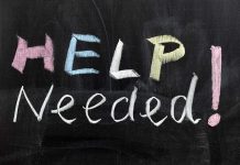 Help Needed written in colorful chalk