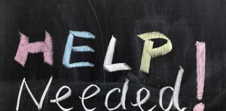 Help Needed written in colorful chalk
