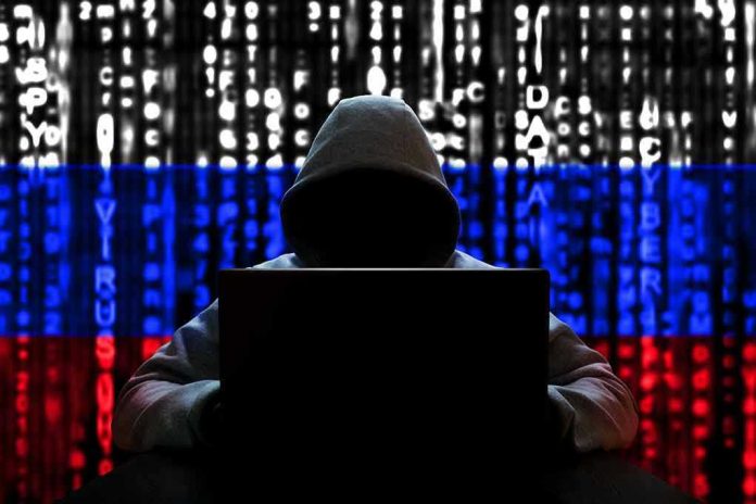 1654709008 Hacker in hoodie with Russian flag background and code