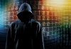 Hooded figure with binary code background