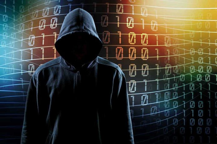 1938583354 Hooded figure with binary code background