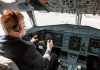 Pilot in cockpit operating airplane controls