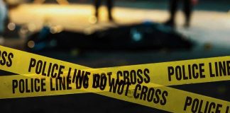Police tape marking a crime scene at night