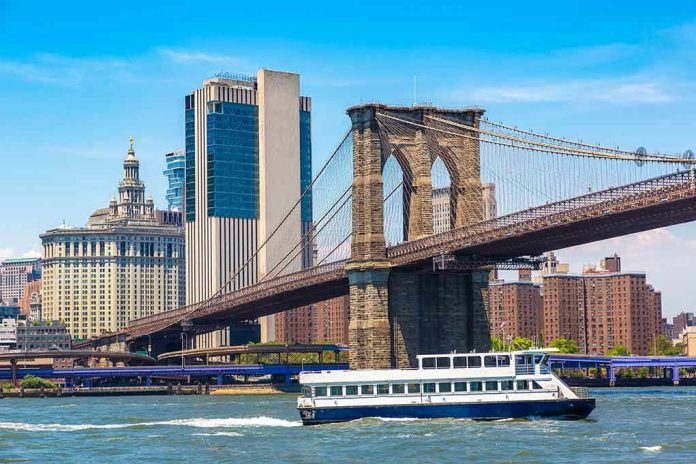 2260438893 Boat passing under Brooklyn Bridge in New York