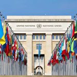 United Nations building with numerous national flags outside