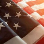 Close up of American flag with sunlit background