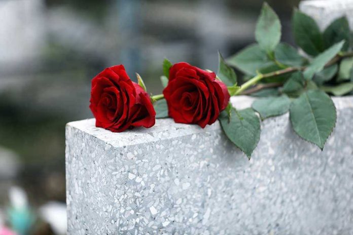 1622846017 Two red roses on a grave