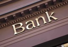 Gold bank sign on building facade