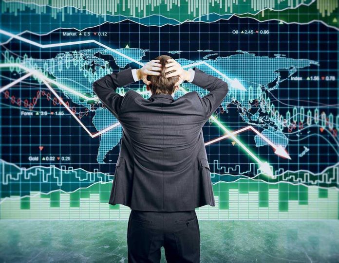 351140789 Person in front of falling stock market graph