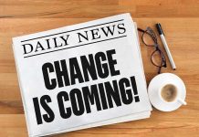 Newspaper headline Change Is Coming on table