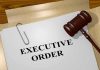 A gavel resting on a document labeled EXECUTIVE ORDER