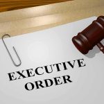 A gavel resting on a document labeled EXECUTIVE ORDER