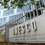 Exterior view of the UNESCO building with a prominent sign