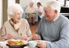 Elderly couple enjoying a meal together in a dining room
