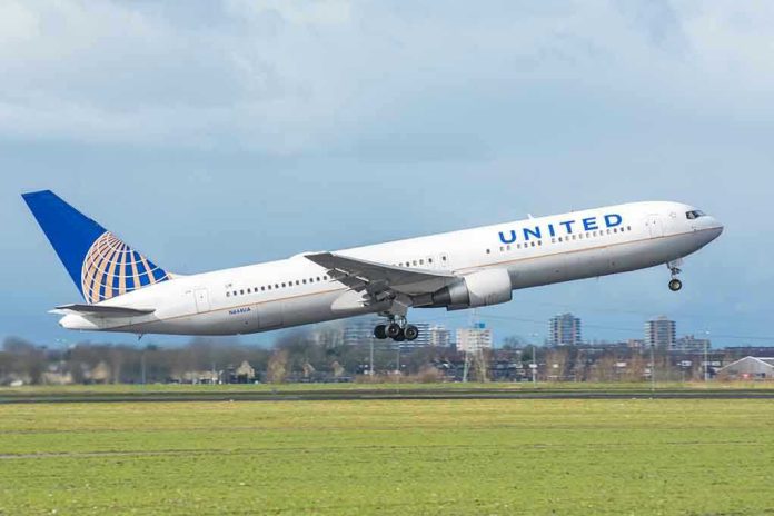 390504661 United airplane taking off from a runway.