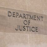 Department of Justice sign on a building.