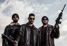 Cartel Gun Haul BUSTED—Border Agents Stunned Three men in sunglasses holding guns, wearing black beanies.