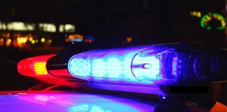 Police car lights flashing red and blue.