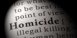 Magnified text showing definition of homicide.