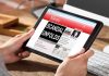 SCANDAL Erupts — Activists Strip Down in Maine Person reading news headline Scandal Unfolds on tablet