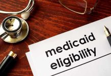 Trump Targets Governor—Medicaid Under Siege Stethoscope pen document about Medicaid eligibility on table