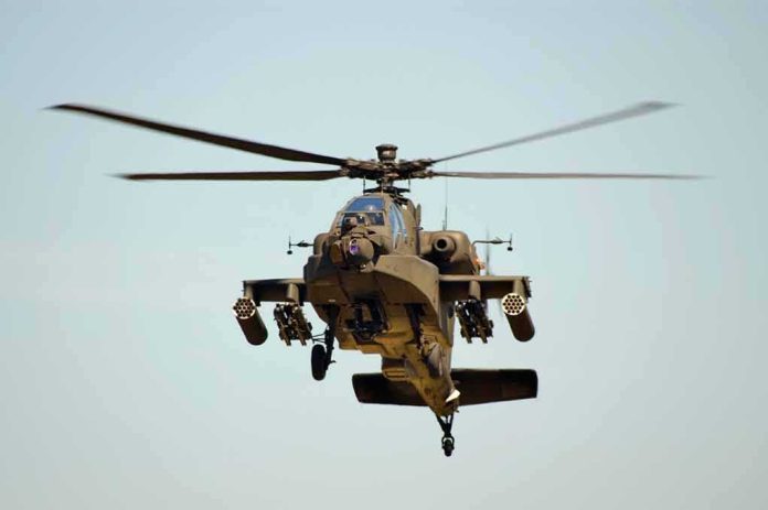 shutterstock_11072761.jpg Military Apache helicopter flying in the sky