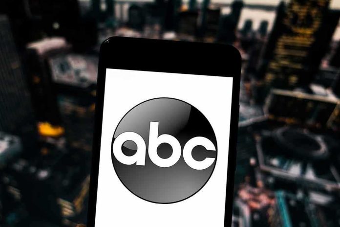 shutterstock_1351717706.jpg A smartphone displaying the ABC logo against an urban backdrop