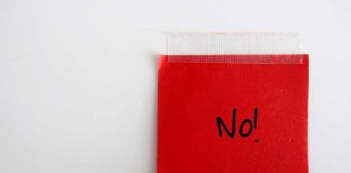 A red sticky note with the word No written in black ink