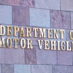 Sign for the Department of Motor Vehicles on a stone wall