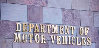 Sign for the Department of Motor Vehicles on a stone wall