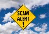 Fraud Shocker — Viral Assault Claim Was a Scam! Yellow warning sign displaying 'SCAM ALERT!' against a cloudy blue sky