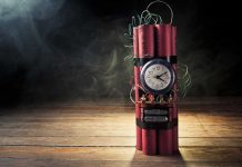 BOMB Drama — Capitol EVACUATED A stick of dynamite with a clock timer and wires, set against a dark smoky background