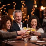 Dissolvable Mint Wards Off Alcohol Cravings People laughing while clinking glasses at a bar