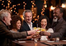 Dissolvable Mint Wards Off Alcohol Cravings People laughing while clinking glasses at a bar