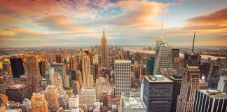 Aerial view of New York City skyline during sunset with skyscrapers and clouds