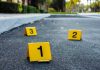 Workplace Horror — 3 Employees Executed in Cold Blood Crime scene markers on asphalt with bullet casing.