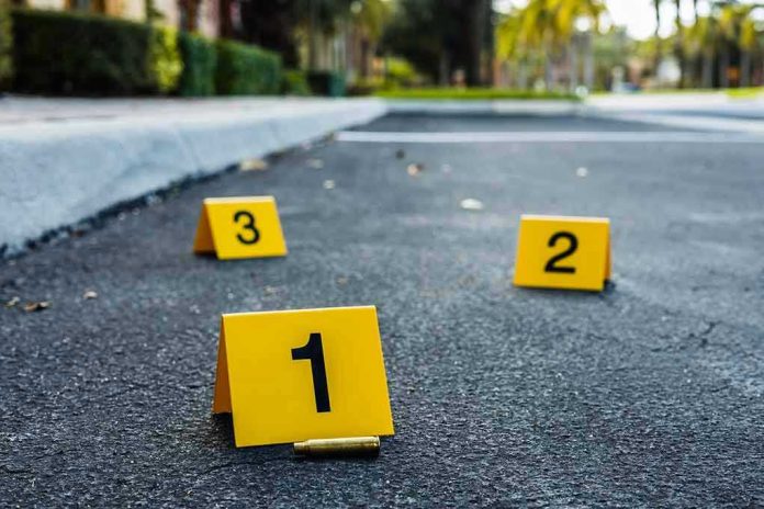 Crime scene markers on asphalt with bullet casing.
