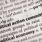 Close-up of a dictionary entry for political action committee