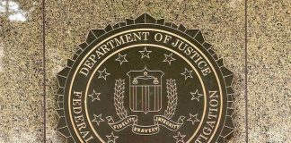 Kash Patel Blasts Baseless Claims, FBI Distracted FBI seal on a marble wall.